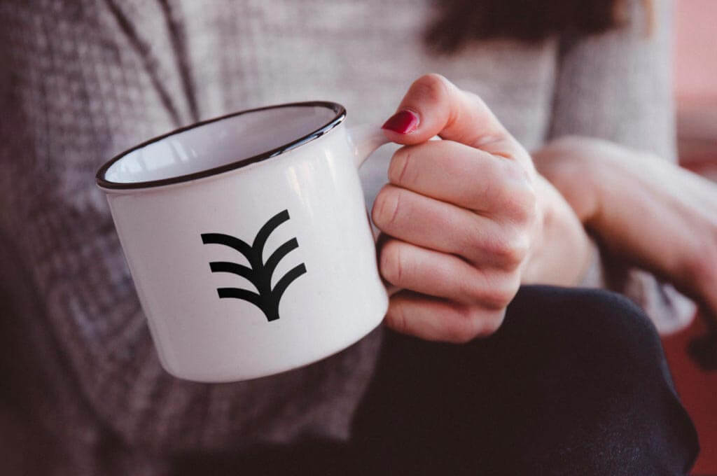 Hand Holding Metal Mug Mockup